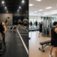 Hyrox vs traditional gym workouts comparison showing athletes training in a fitness center